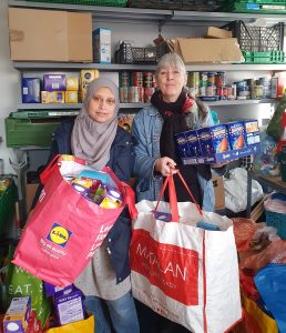 Image of Cllr Kerry Jenkins handing over easter eggs to a volunteer at Kings Heath Foodbank.K