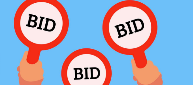 3 signs being held up, each of them reading "BID"